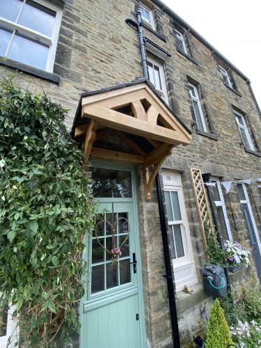 Solid oak porch canopy by TF Building and Renovations